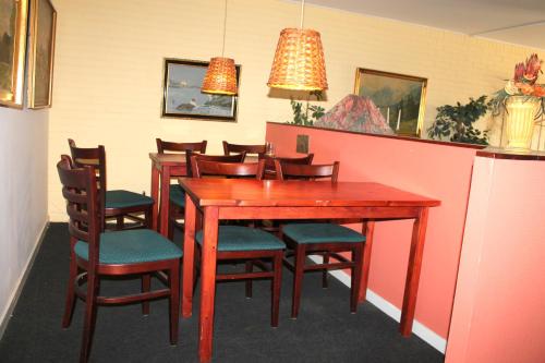 a dining room with a wooden table and chairs at Medio Apartments in Fredericia