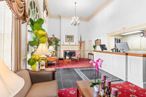 a living room with a couch and a fireplace at Rodeway Inn Williamsburg Historic Area in Williamsburg