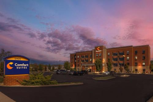 a building with a sign in front of a parking lot at Comfort Suites Florence - Cincinnati South in Florence