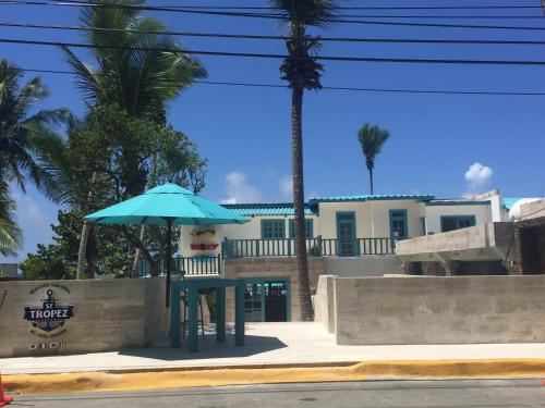 a blue umbrella sitting in front of a building at Vista Marina Residence in Boca Chica