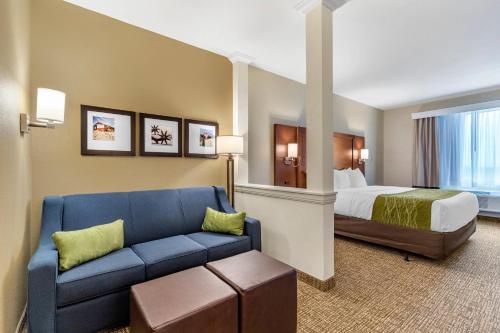a hotel room with a bed and a couch at Comfort Suites San Antonio Ft Sam Houston-SAMMC Area in San Antonio