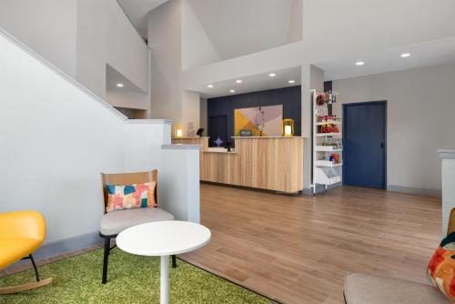 a waiting room with a chair and a table at Spark by Hilton El Paso University in El Paso