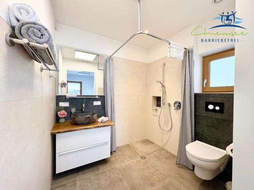 a bathroom with a toilet and a shower at Panorama Apartments by Chiemsee barrierefrei in Nußdorf
