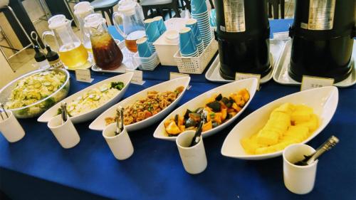a blue table topped with bowls of different foods at Toyoko Inn Osaka Kadoma-shi Ekimae in Osaka