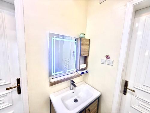 a bathroom with a sink and a window at شاليهات سكون الغروب in Taif