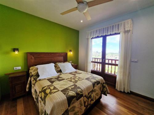 a bedroom with green walls and a bed with a window at Hotel Verdemar by Grupo A Cobijo in Lamadrid