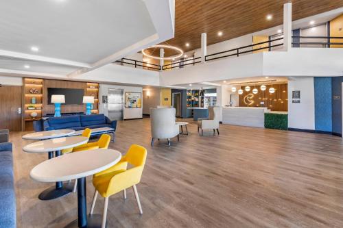 a lobby with tables and chairs and a couch at Comfort Inn & Suites Irvine Spectrum in Lake Forest