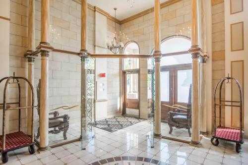 a large room with columns and a large mirror at St Christophe Hotel & Spa, an Ascend Collection Hotel in Granby