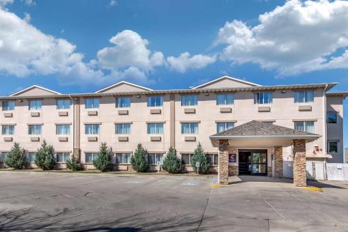 a large white building with a parking lot at Comfort Inn Great Falls South in Great Falls