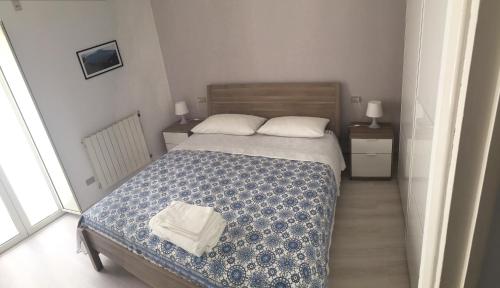 a small bedroom with a bed and two night stands at Vacanze a Gaeta in Gaeta