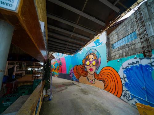 a wall with a painting of a woman on it at Turtle Beach Resort in San Juan