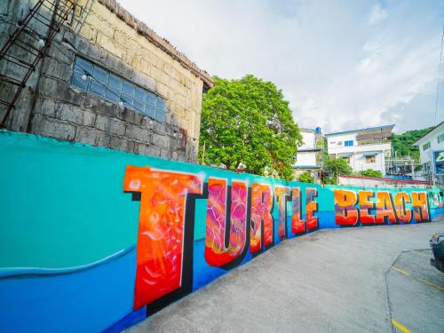 a fence with the word teddy bear painted on it at Turtle Beach Resort in San Juan