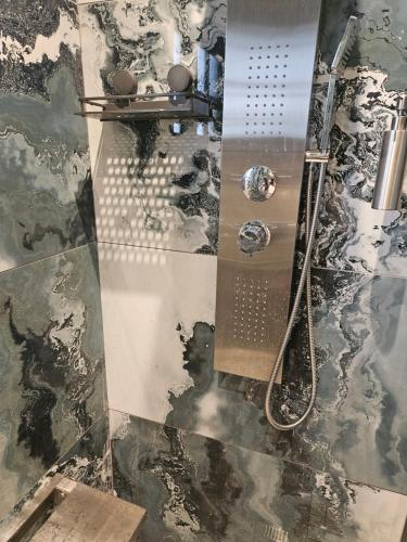 a bathroom with a shower and a glass floor at Little Germany in Waterfall