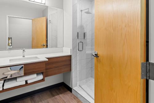 a bathroom with a sink and a shower at Park Inn by Radisson, Kelowna in Kelowna