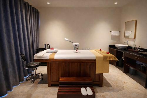 a bathroom with a bed and a sink in a room at Astralis Resort Coorg in Madikeri