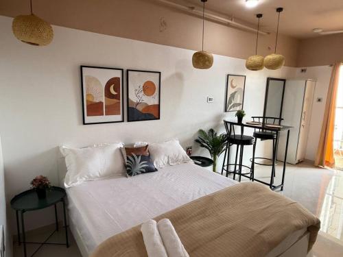 a bedroom with a large bed and a table at Private Studio Apartments with Balcony in New Kalyani Nagar in Pune