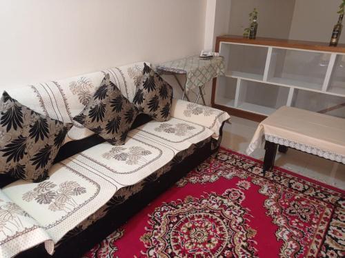 a living room with a couch and a rug at sariska farmhouse villa in Alwar
