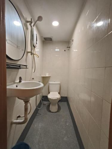 a bathroom with a sink and a toilet and a mirror at Swing & Pillows - Bukit Tinggi, Klang in Klang