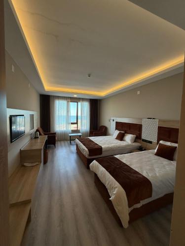 a hotel room with two beds and a couch at Mitra Black Sea in Arhavi