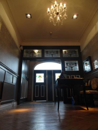 a room with a door and a chandelier at Boreland Lodge Hotel in Inverkeithing