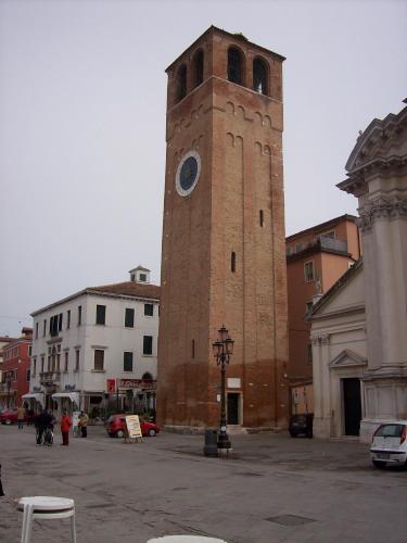 a tall tower with a clock on top of it at Hotel Touring in Sottomarina