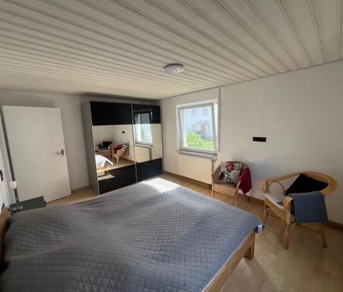 a bedroom with a large bed and a window at Ferienwohnung im Täle in Bad Überkingen