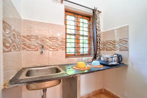 a kitchen with a sink and a window at Hotel Calangute bay in Calangute