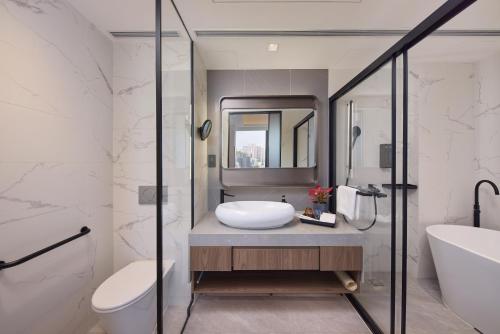 a bathroom with a sink and a toilet at Rosedale Hotel Hong Kong in Hong Kong