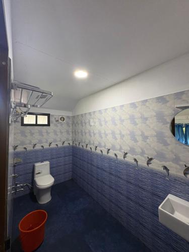 a bathroom with a toilet and a sink at FroZen NeST in Vagamon