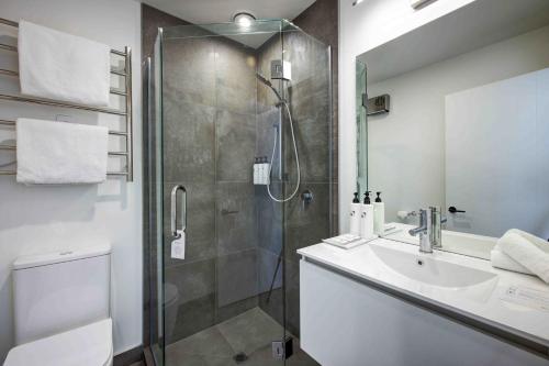 a bathroom with a shower and a sink at Swiss-Belvillas Coronet Peak in Queenstown