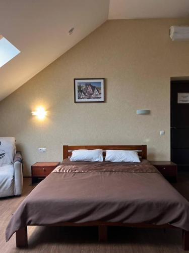 a bedroom with a large bed in a room at BavariaHotel in Kharkiv