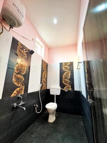 a bathroom with a toilet and a shower at Dreamy serenity beach side in Pondicherry