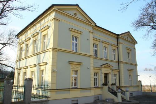 a large yellow building with a turret at Penzion U sv. Kryštofa in Prague