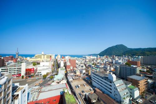 an aerial view of a city with buildings at Hotel Seawave Beppu in Beppu