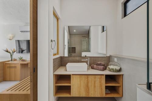 a bathroom with a sink and a mirror at Coral Azur Beach Resort Mont Choisy in Mont Choisy