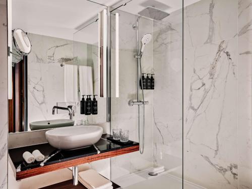 a bathroom with a sink and a shower at Radisson Collection Hotel, Berlin in Berlin