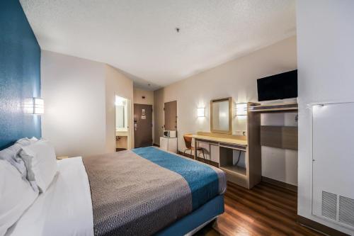 a hotel room with a bed and a desk at Motel 6 New Braunfels in New Braunfels
