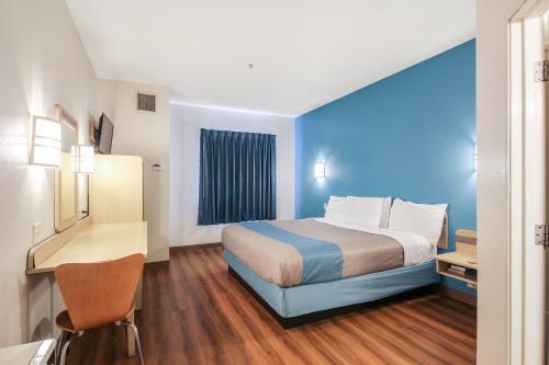 a hotel room with a bed and a desk at Motel 6 New Braunfels in New Braunfels