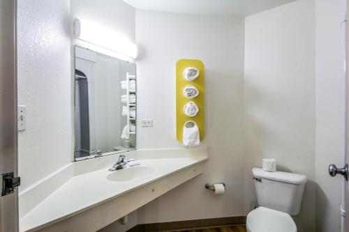 a bathroom with a sink and a toilet and a mirror at Motel 6 New Braunfels in New Braunfels