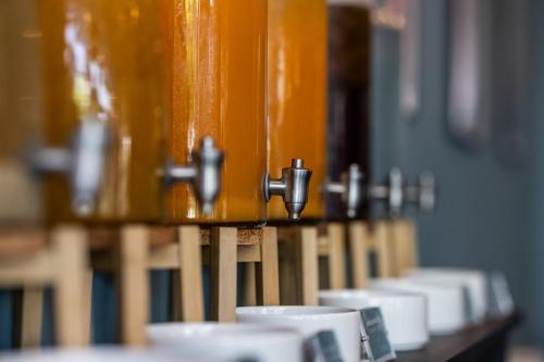 a row of coffee cups sitting on a shelf at Hotel Kolding in Kolding