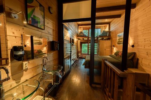 a bathroom with a sink and a bed in a room at PinusVillas Private Jacuzzi & Phyto-Sauna in Zheleznitsa