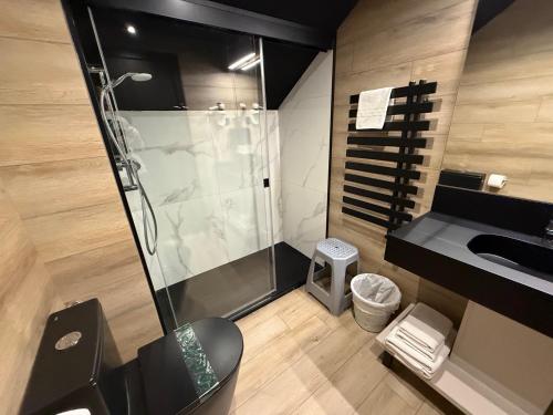 a bathroom with a shower and a sink at Hotel Guineu in Pas de la Casa
