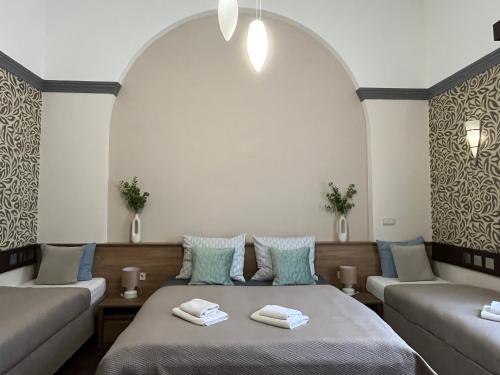 a room with two beds and a couch at Mohács Korona Apartman in Mohács