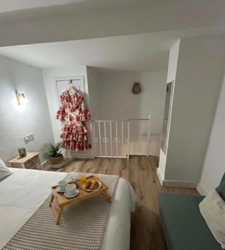 a bedroom with a bed and a table in a room at Las Marismas-Puente del Rey in El Rocío