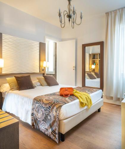 a bedroom with a large bed with a purse on it at Maison Spada in Venice