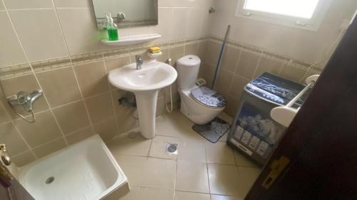 a bathroom with a sink and a toilet at Abu Dhabi Cozy studio in Abu Dhabi