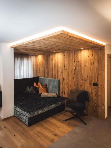 a living room with a couch and a chair at Paradeis Apartments in Mühlbach