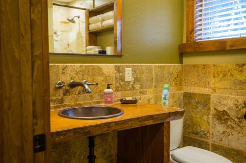 a bathroom with a sink and a toilet at Baycrest Lodge in Homer