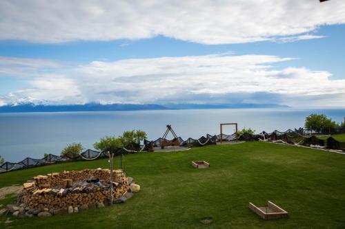 a group of tents on a field next to the water at Baycrest Lodge in Homer