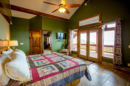 a bedroom with green walls and a bed with a window at Baycrest Lodge in Homer